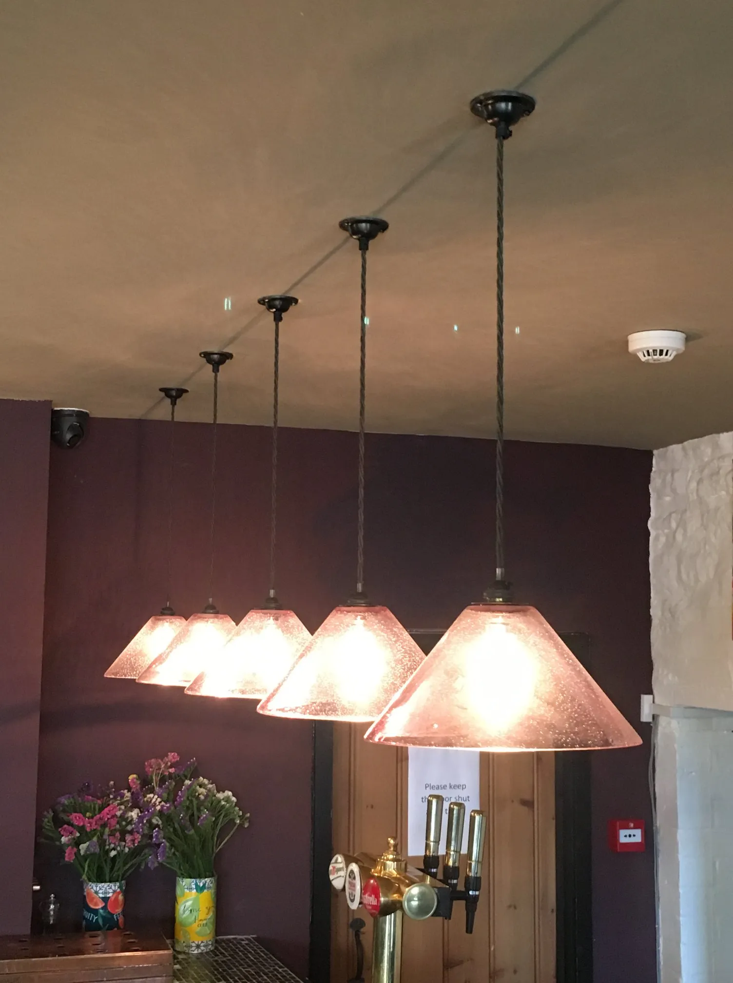 a kitchen with a bunch of lights hanging from the ceiling