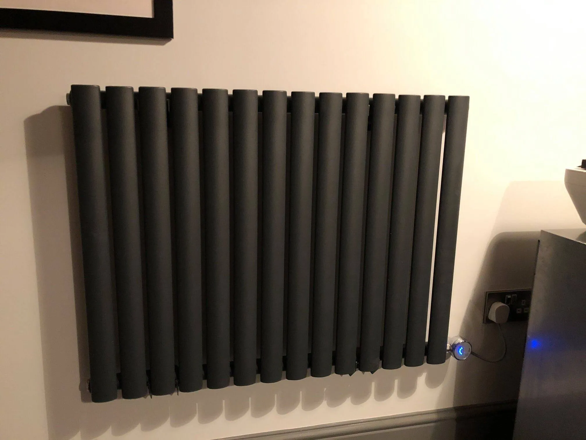 a radiator in a bathroom with a sink